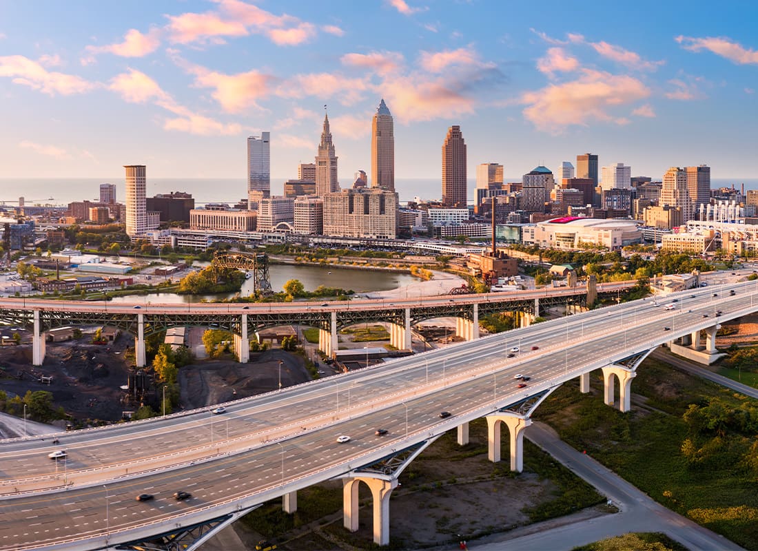 Cleveland, OH - Aerial View of Cleveland, Ohio Skyline and I90 Interstate Highway at Sunset